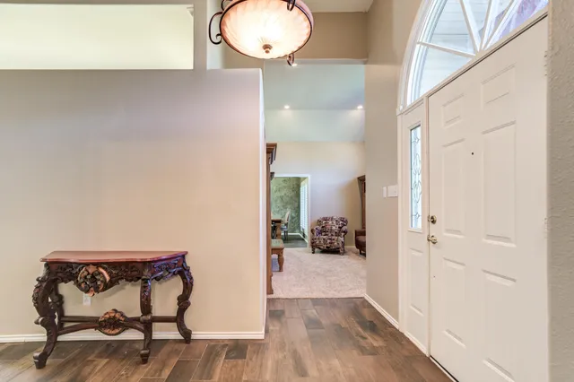 a kitchen with stainless steel appliances kitchen island hardwood floor and a sink