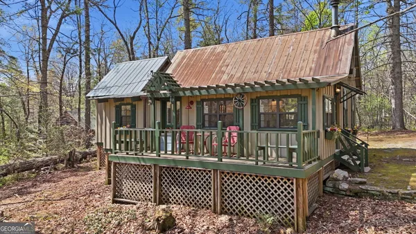 a view of a house with a wooden fence