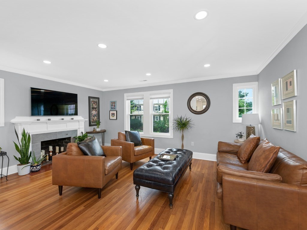 34 Watson Road, Unit 34 Belmont, MA 02478 - Photo 3 of 26 a living room with furniture a fireplace and a flat screen tv