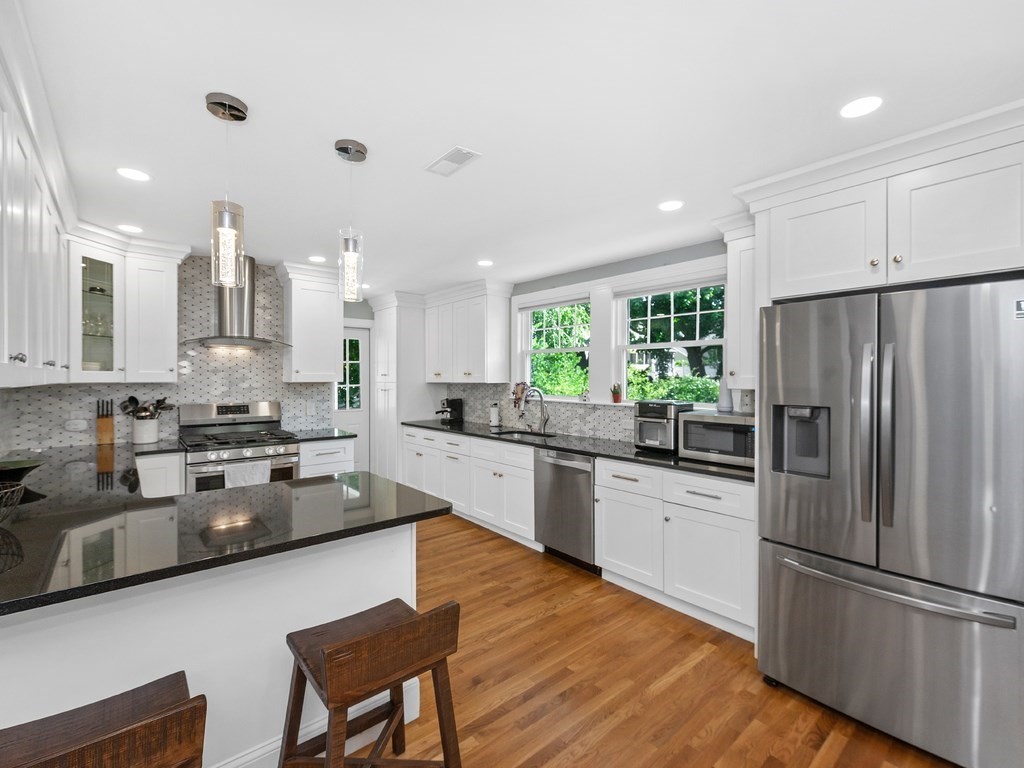 34 Watson Road, Unit 34 Belmont, MA 02478 - Photo 8 of 26 a kitchen with stainless steel appliances granite countertop a refrigerator sink and white cabinets