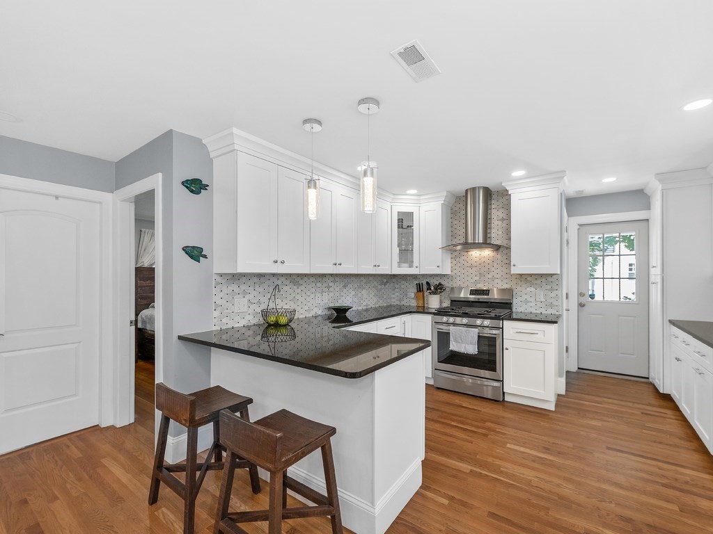34 Watson Road, Unit 34 Belmont, MA 02478 - Photo 9 of 26 a kitchen with stainless steel appliances granite countertop a stove a sink dishwasher and a refrigerator with wooden floor