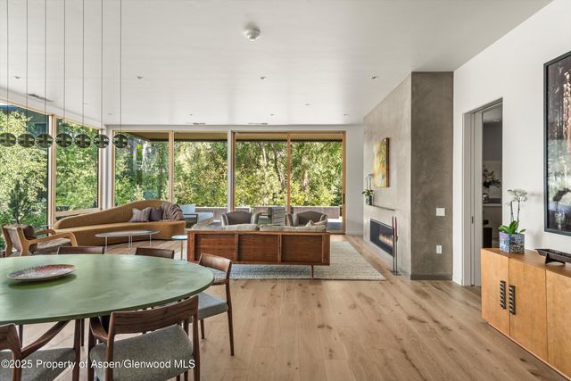 a view of a dining room with furniture window and wooden floor