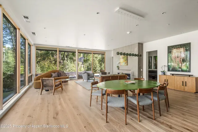 a dining room with furniture window and wooden floor