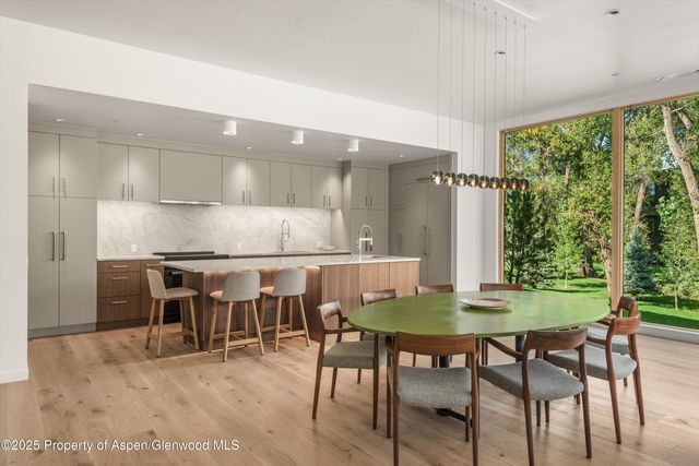 a dining room with furniture and wooden floor