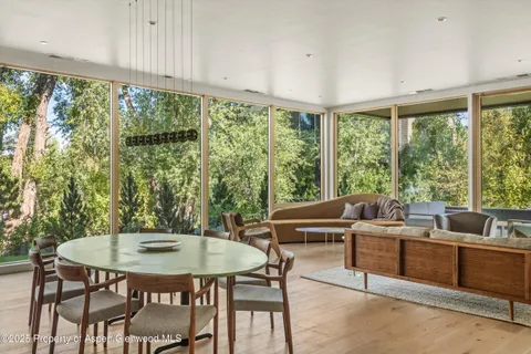 a view of a dining room with furniture window and outside view