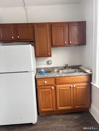 a white refrigerator freezer sitting inside of a kitchen