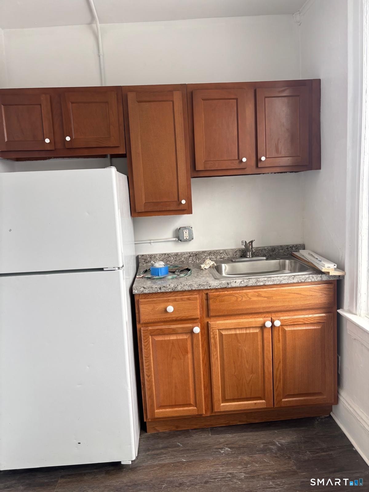 a white refrigerator freezer sitting inside of a kitchen