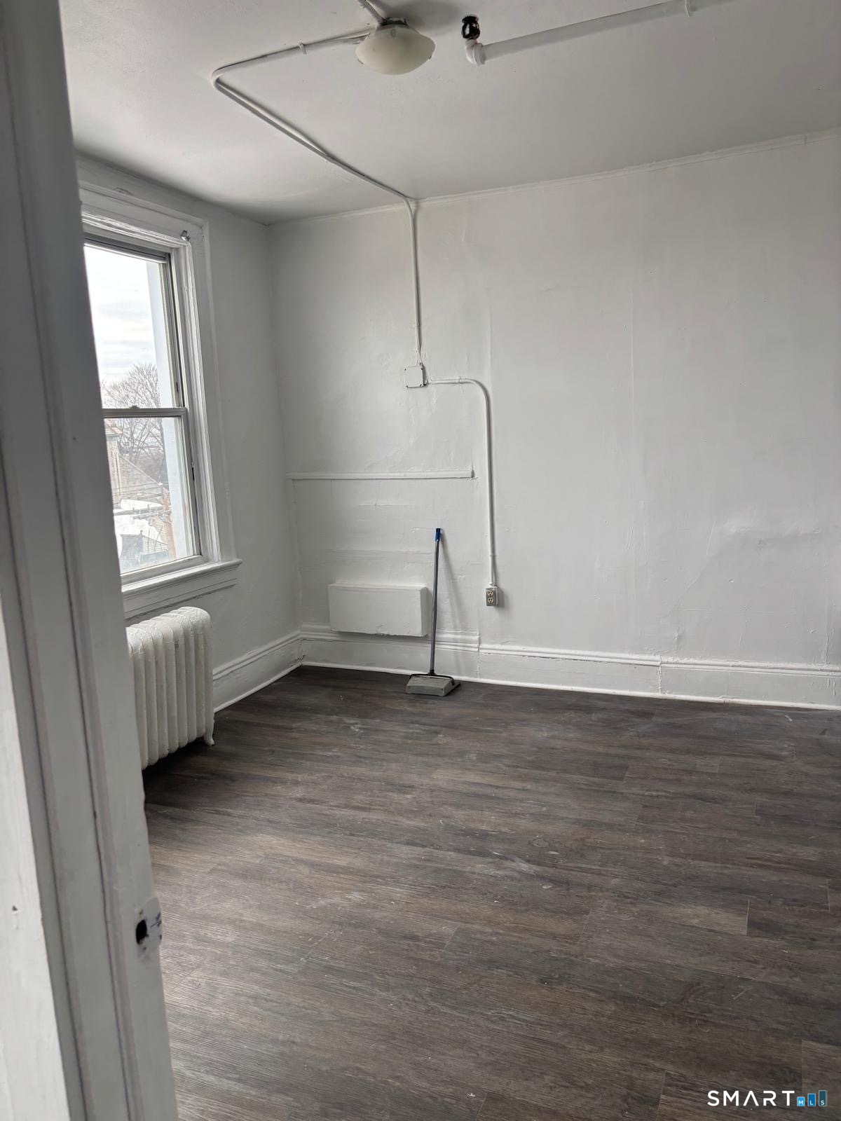 86 Pequonnock Street, Unit 36 Bridgeport, CT 06604 - Photo 3 of 4 a view of a room with wooden floor and window