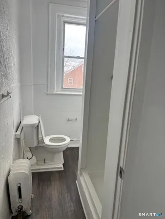 a white toilet sitting next to a bathroom sink