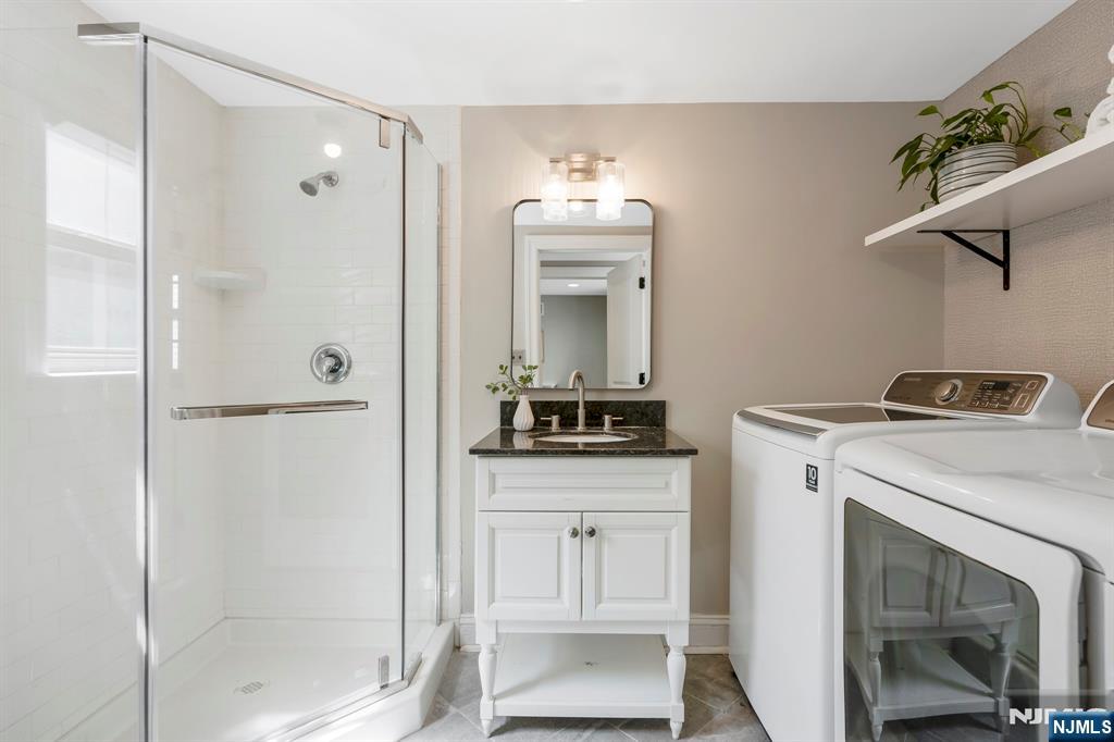 20 West Saddle River Road Waldwick, NJ 07463 - Photo 30 of 39 a bathroom with a granite countertop sink a mirror and a shower