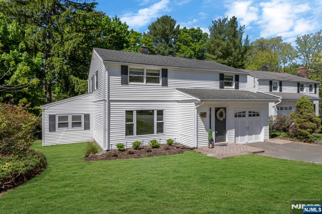 20 West Saddle River Road Waldwick, NJ 07463 - Photo 34 of 39 a front view of a house with a yard and garage
