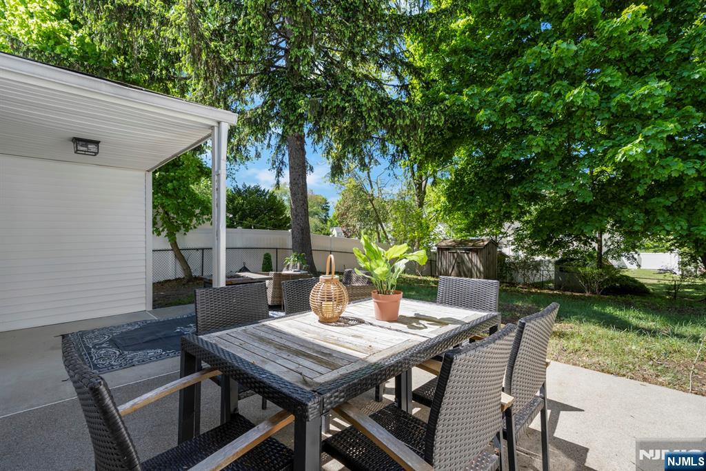 20 West Saddle River Road Waldwick, NJ 07463 - Photo 37 of 39 a view of a patio with table and chairs and potted plants with large tree