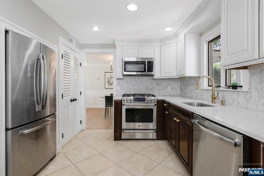 20 West Saddle River Road Waldwick, NJ 07463 - Photo 8 of 39 a kitchen with stainless steel appliances granite countertop a refrigerator sink and microwave