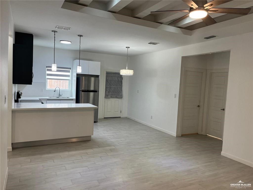 1624 West Marlin Street, Unit 2 Pharr, TX 78577 - Photo 3 of 12 a large kitchen with a large counter top a sink stainless steel appliances and cabinets