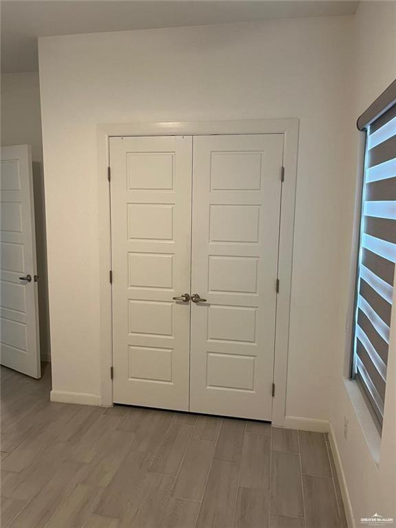 1624 West Marlin Street, Unit 2 Pharr, TX 78577 - Photo 6 of 12 an empty room with a hardwood and white doors