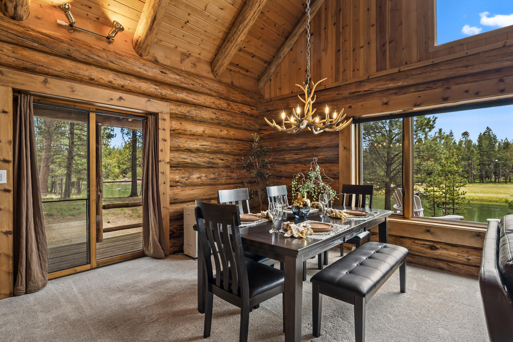 17026 Sharp Drive Bend, OR 97707 - Photo 27 of 72 a view of a dining room with furniture a chandelier and large windows
