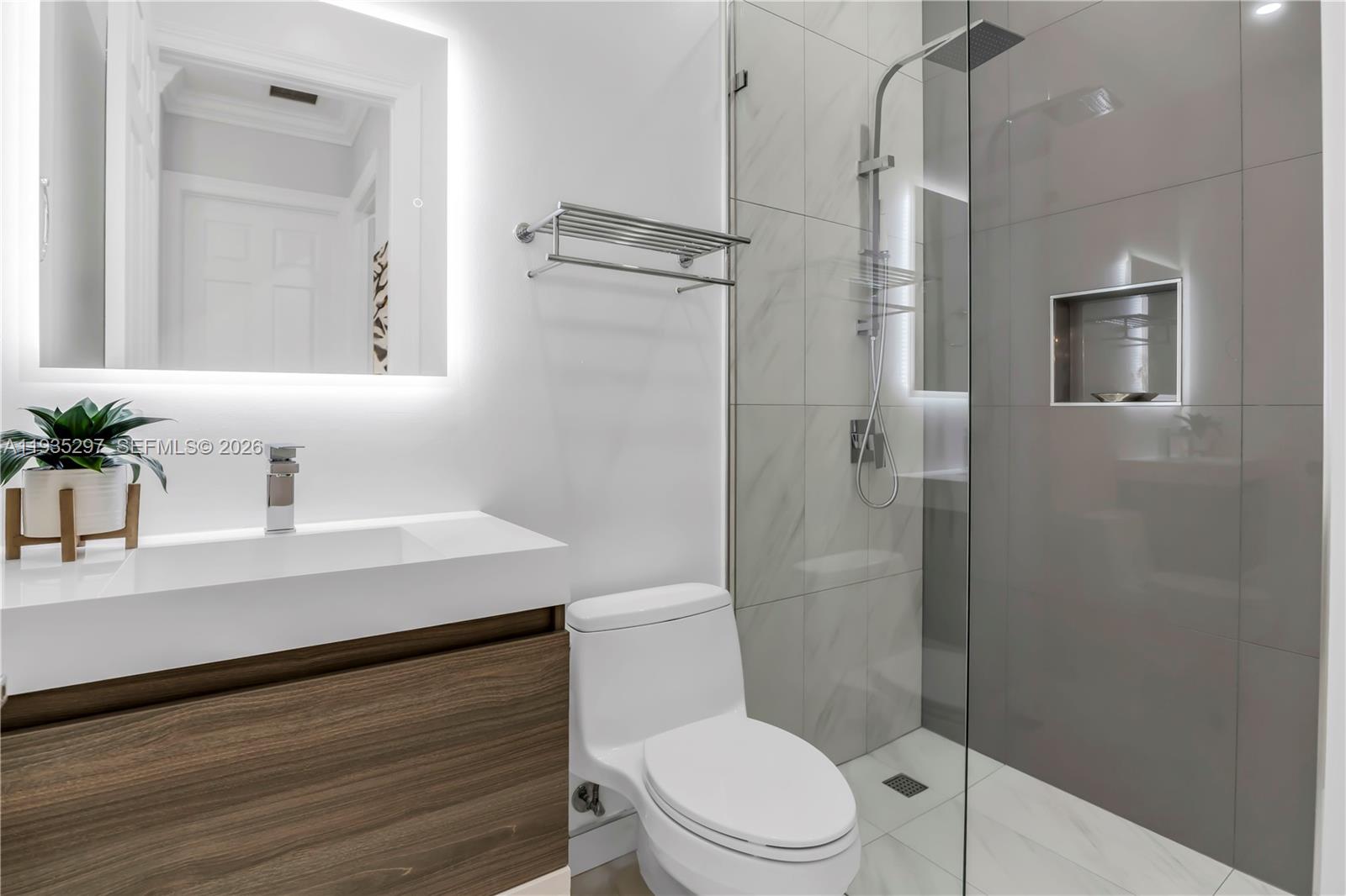 5311 Southwest 184th Way Miramar, FL 33029 - Photo 34 of 81 a bathroom with a sink a toilet a shower and a mirror