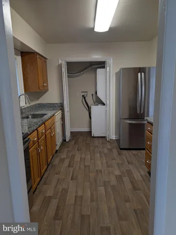 a view of a kitchen from a hallway
