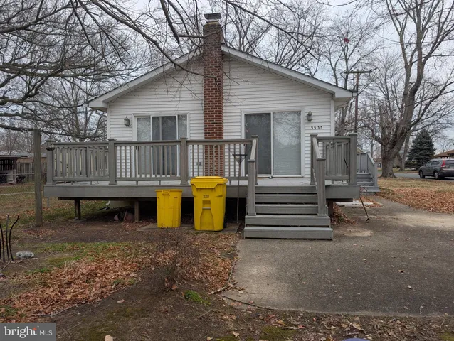 a view of a house with a yard and wooden fence