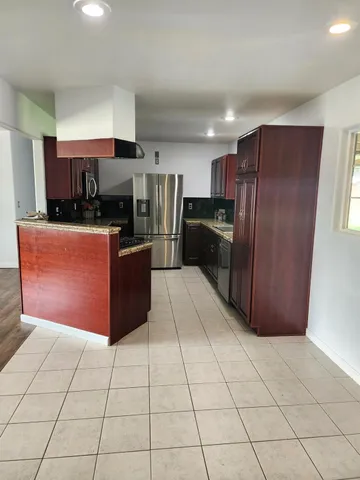 a kitchen with a refrigerator sink and stove