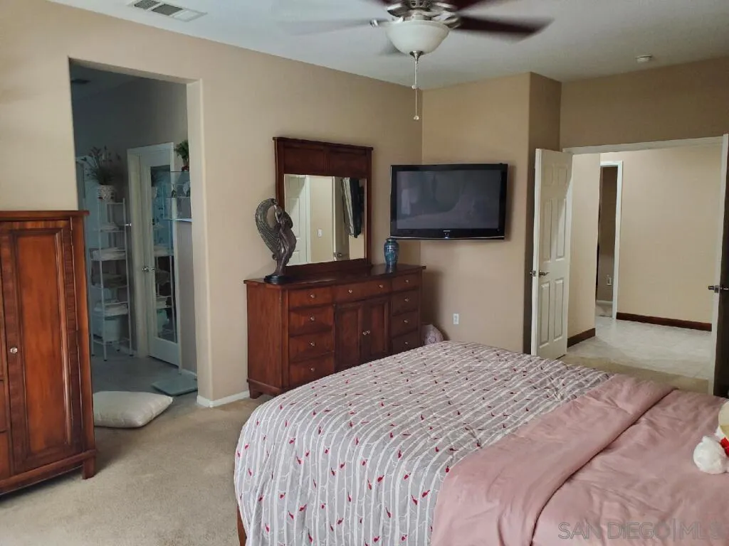 29850 Winter Hawk Road Menifee, CA 92586 - Photo 20 of 25 a bedroom with a bed and a flat screen tv