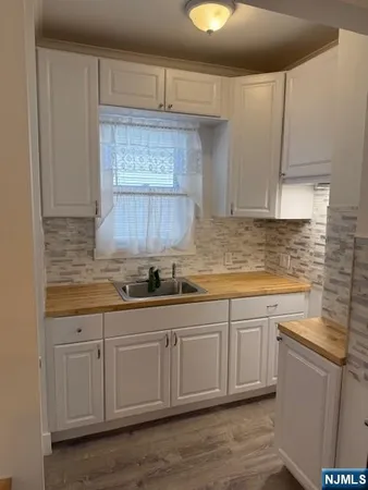 a kitchen with sink cabinets and window