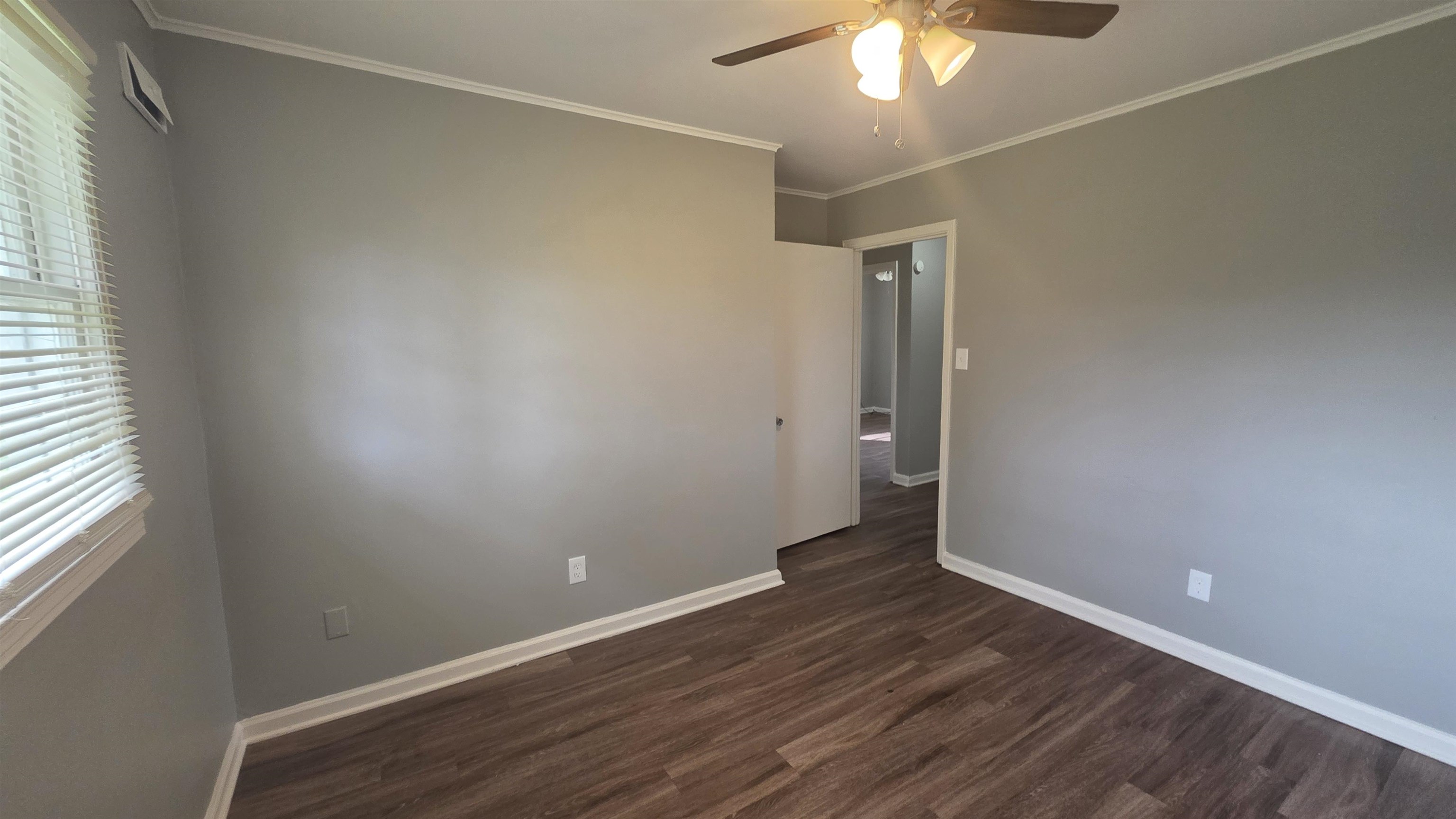 273 Clower Road Memphis, TN 38109 - Photo 11 of 11 an empty room with wooden floor and windows