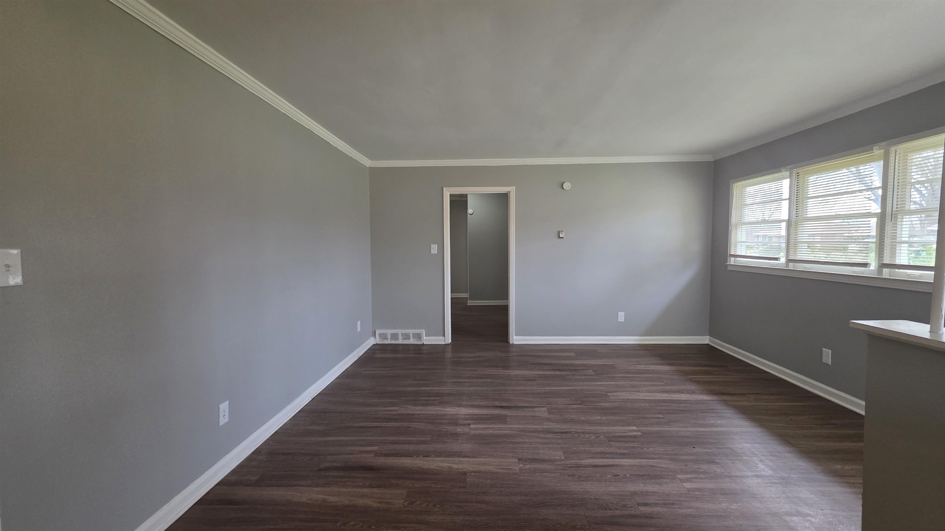 273 Clower Road Memphis, TN 38109 - Photo 6 of 11 a view of an empty room with wooden floor and a window
