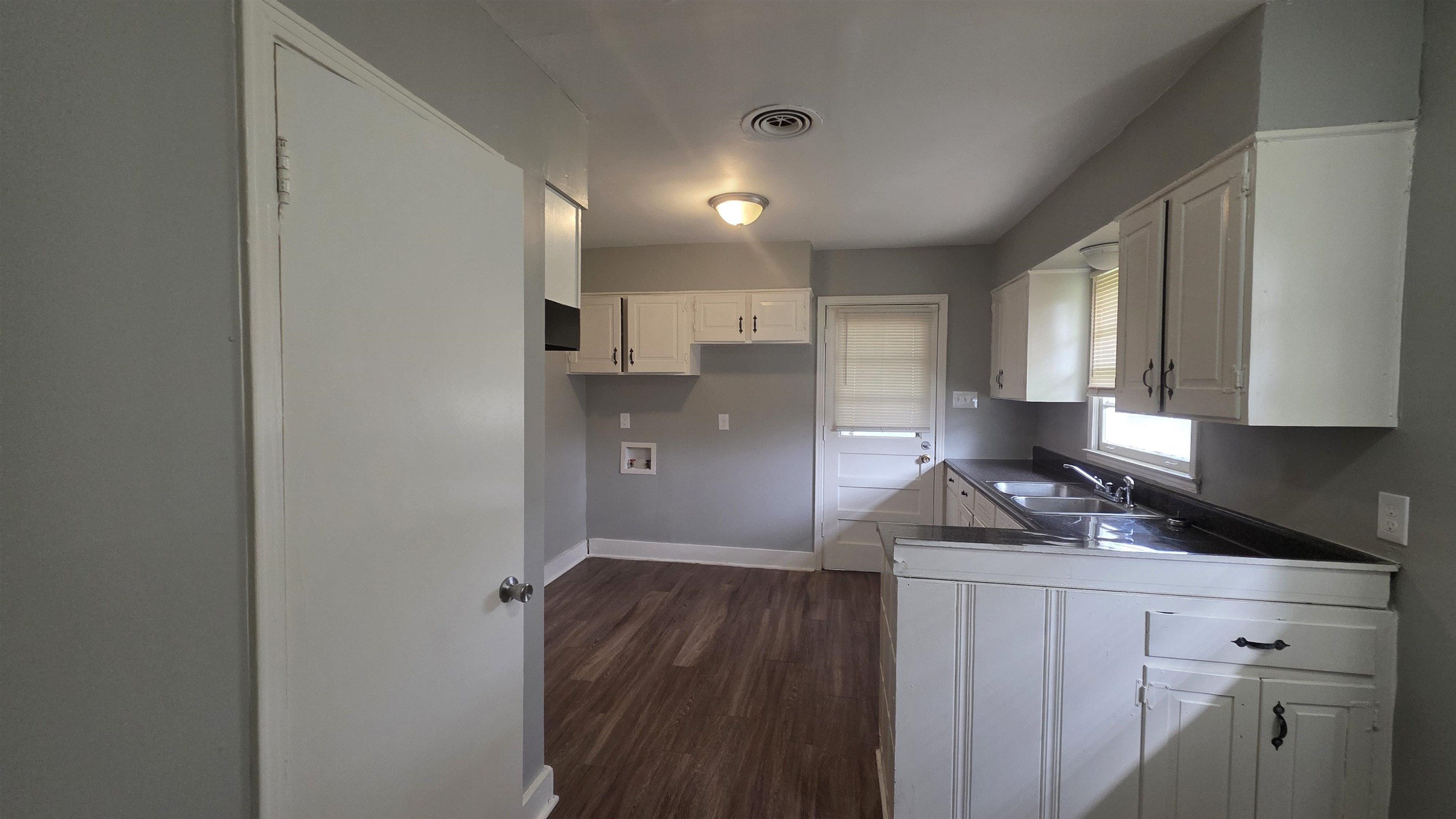 273 Clower Road Memphis, TN 38109 - Photo 7 of 11 a kitchen with granite countertop white cabinets and stainless steel appliances