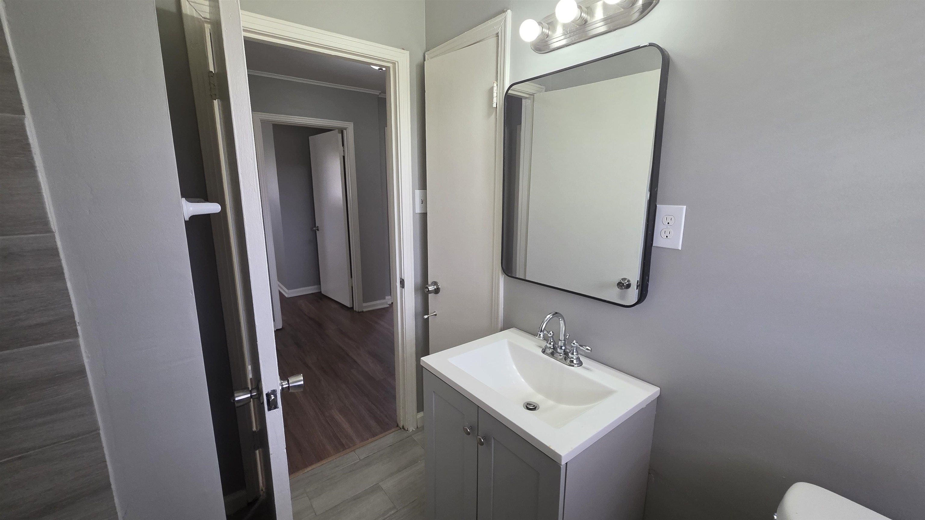273 Clower Road Memphis, TN 38109 - Photo 10 of 11 a bathroom with a sink toilet and mirror