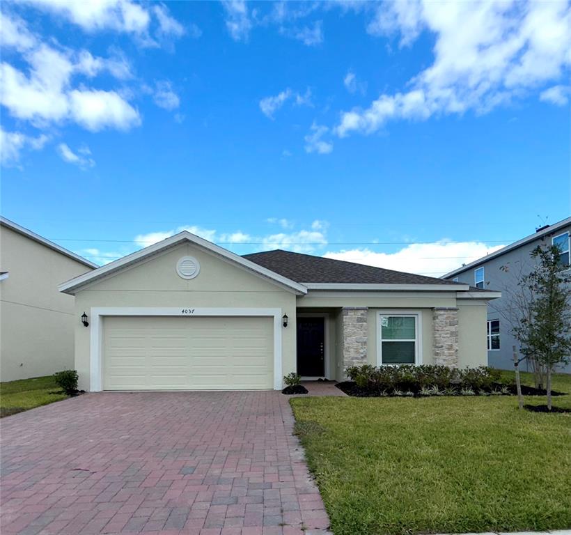 4057 Serene Water Avenue Eustis, FL 32736 - Photo 2 of 2 a front view of a house with a garden and yard