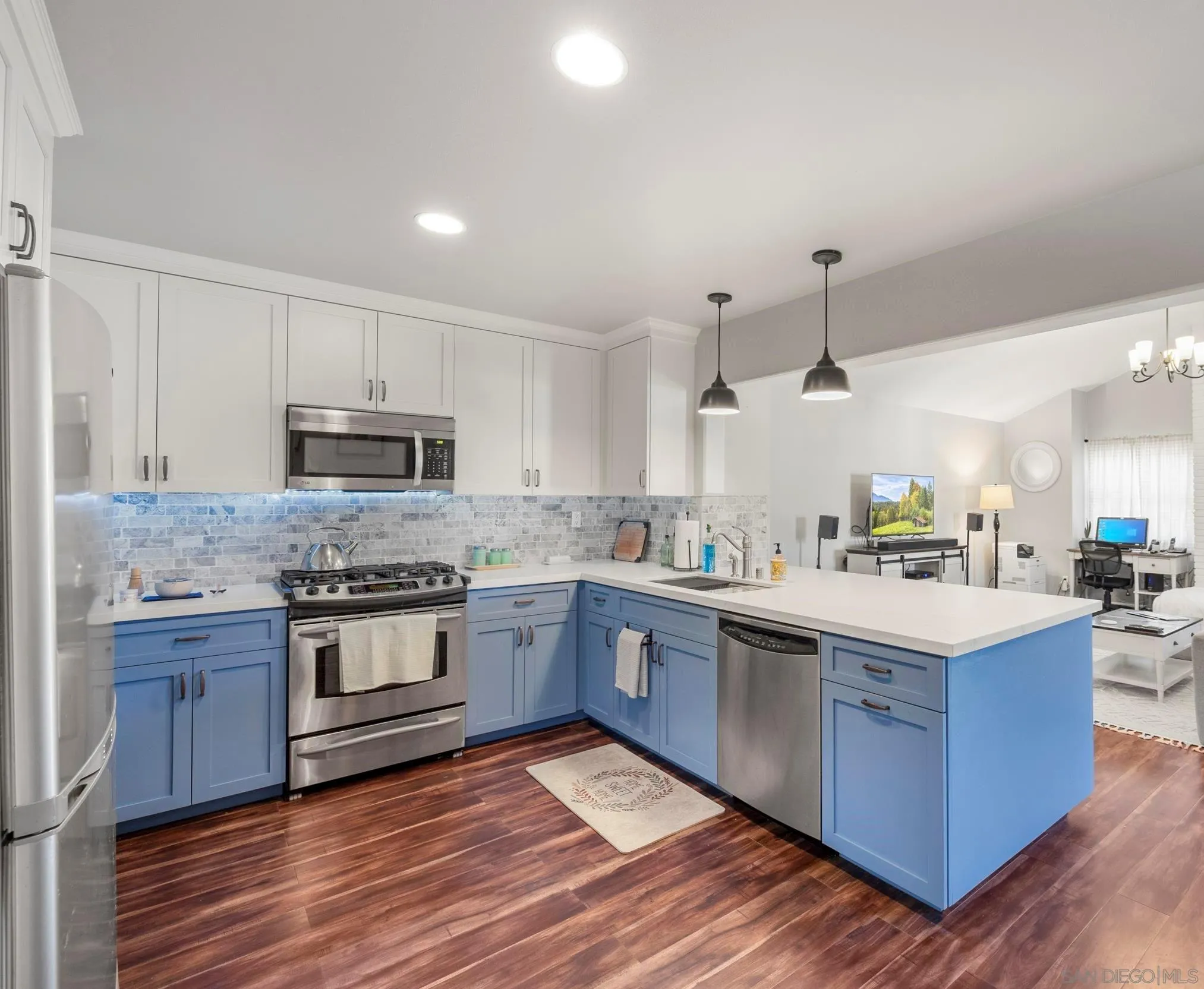a kitchen with stainless steel appliances granite countertop a stove top oven and sink