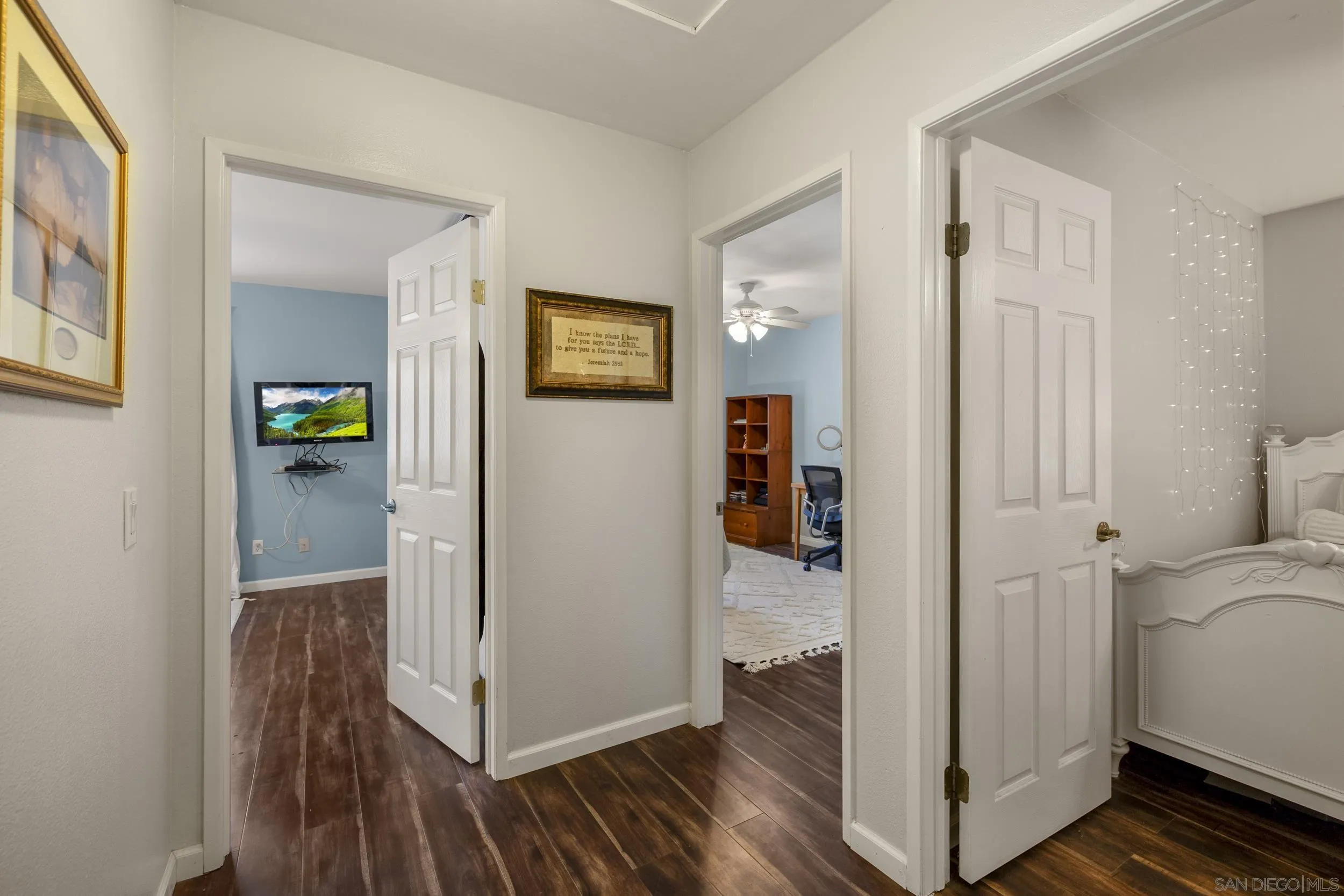 4652 Briar Ridge Road Oceanside, CA 92056 - Photo 15 of 34 a view of a hallway with wooden floor and dining room