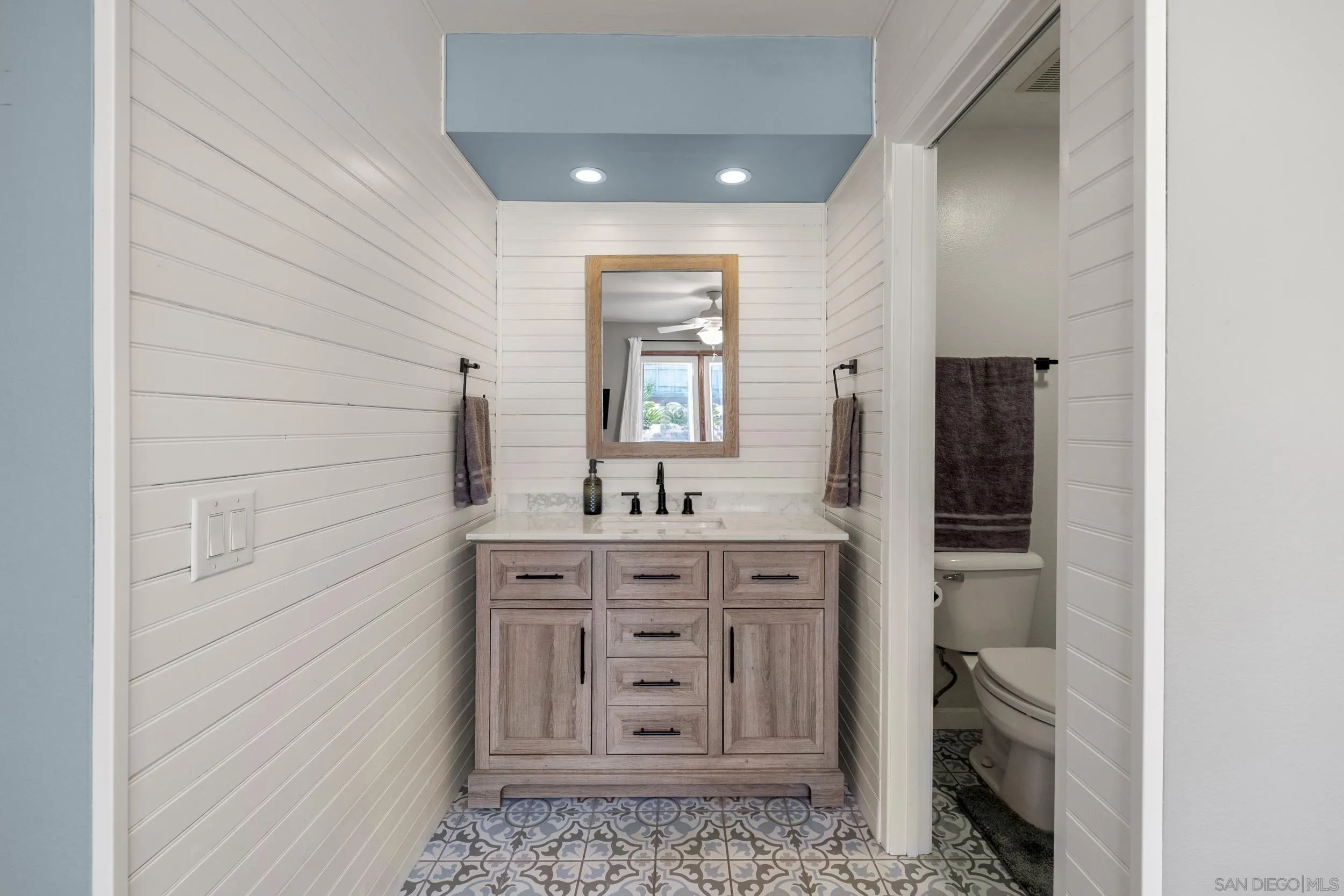 4652 Briar Ridge Road Oceanside, CA 92056 - Photo 17 of 34 a bathroom with a vanity and a mirror