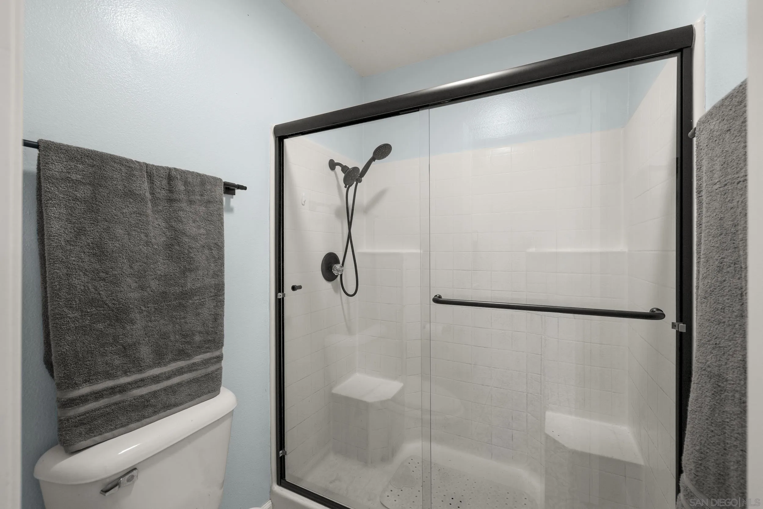 4652 Briar Ridge Road Oceanside, CA 92056 - Photo 18 of 34 a bathroom with a glass shower door