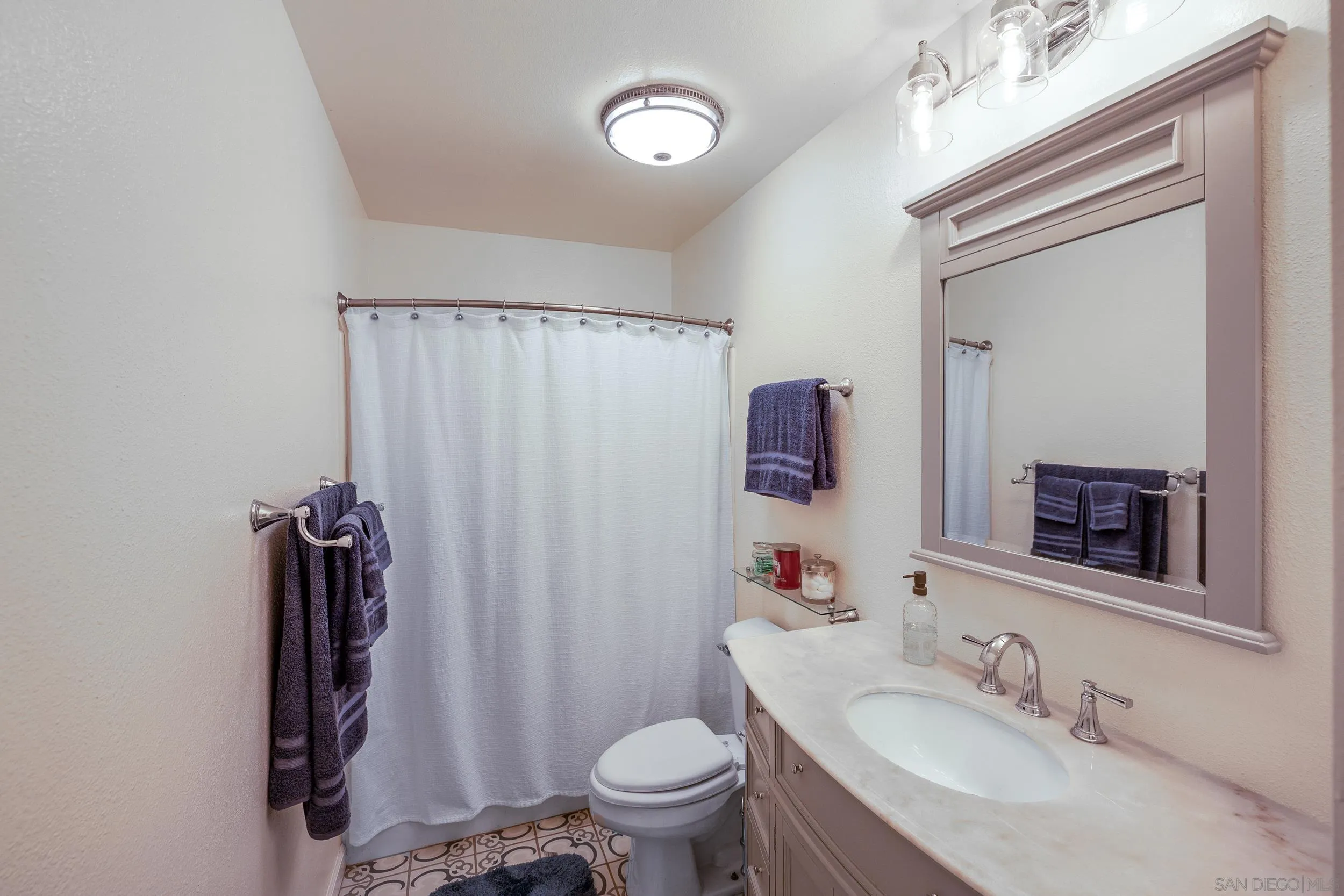4652 Briar Ridge Road Oceanside, CA 92056 - Photo 20 of 34 a bathroom with a sink vanity mirror and toilet