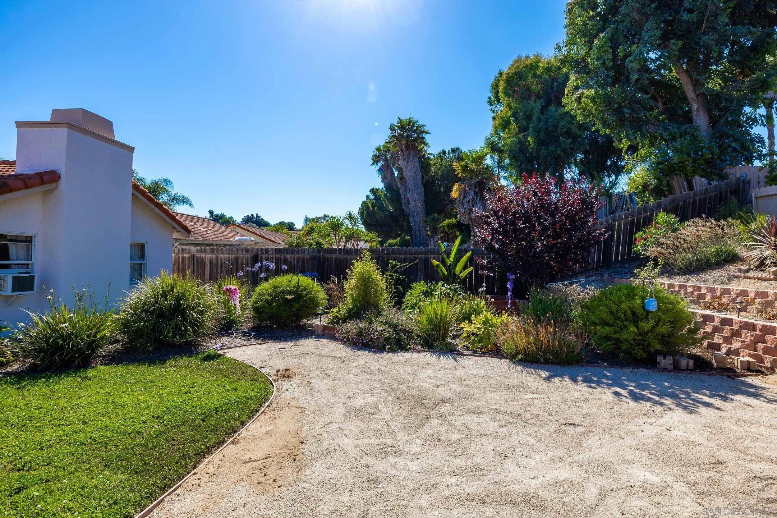 4652 Briar Ridge Road Oceanside, CA 92056 - Photo 26 of 34 a view of a garden with a house