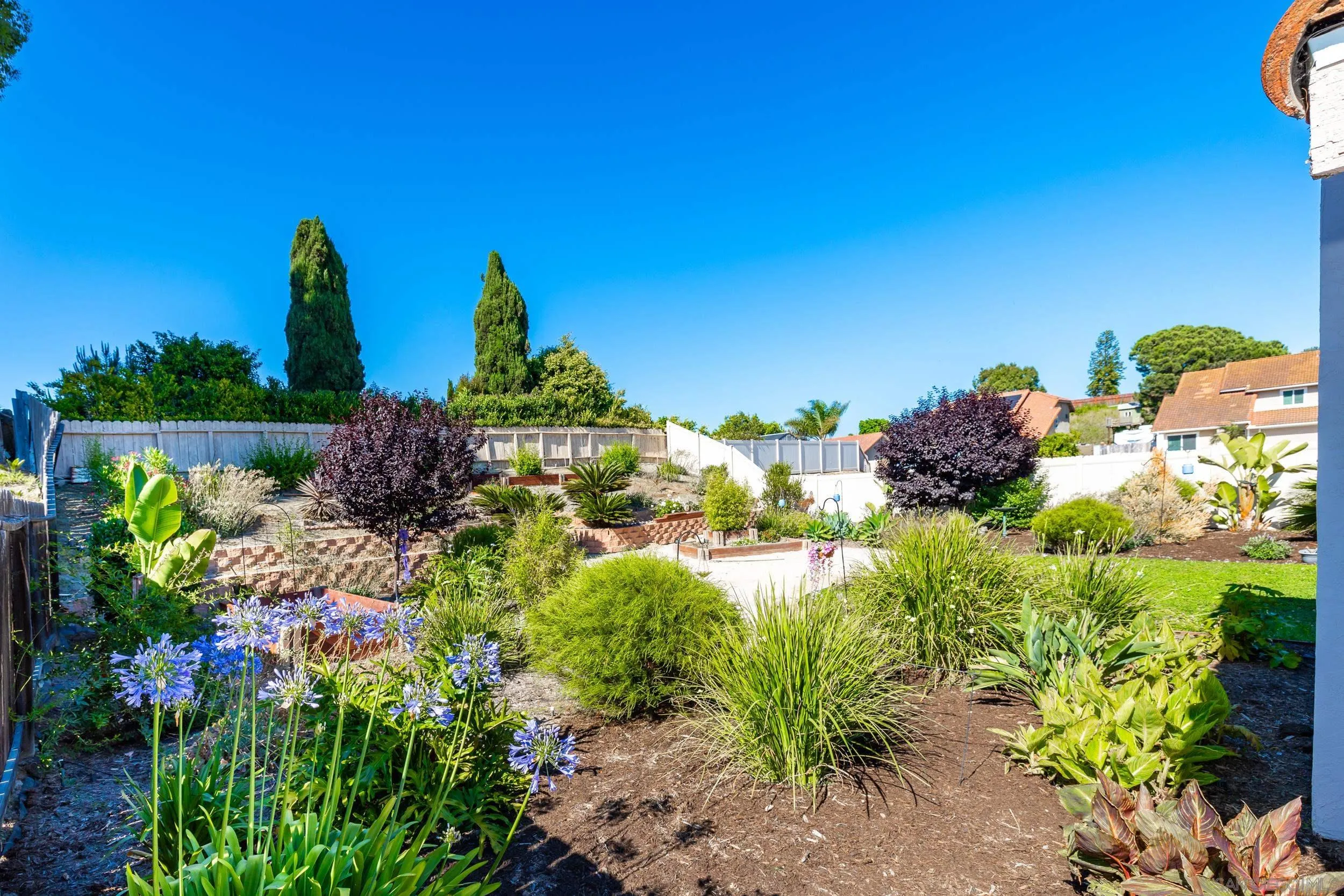 4652 Briar Ridge Road Oceanside, CA 92056 - Photo 27 of 34 a view of a garden with a flower garden