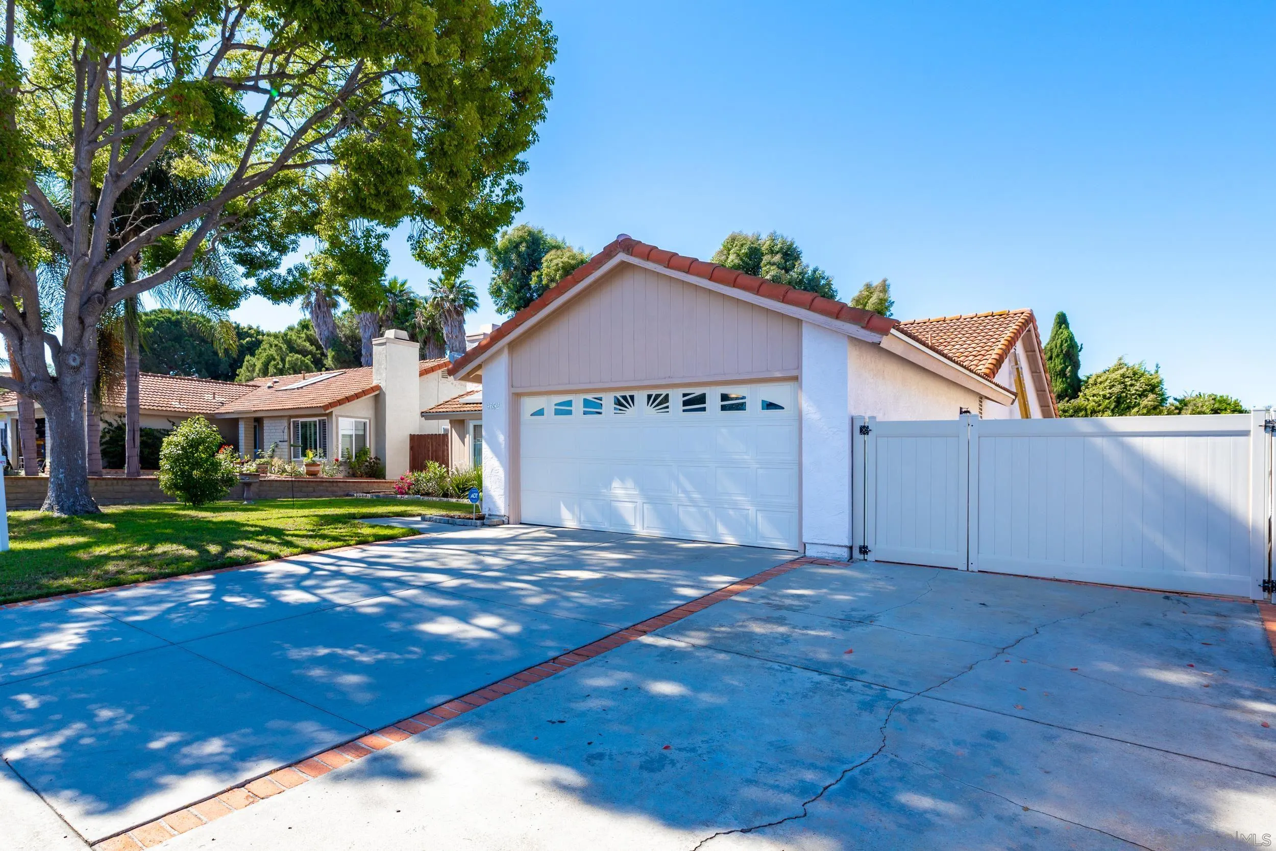 4652 Briar Ridge Road Oceanside, CA 92056 - Photo 31 of 34 a front view of a house with a yard and garage