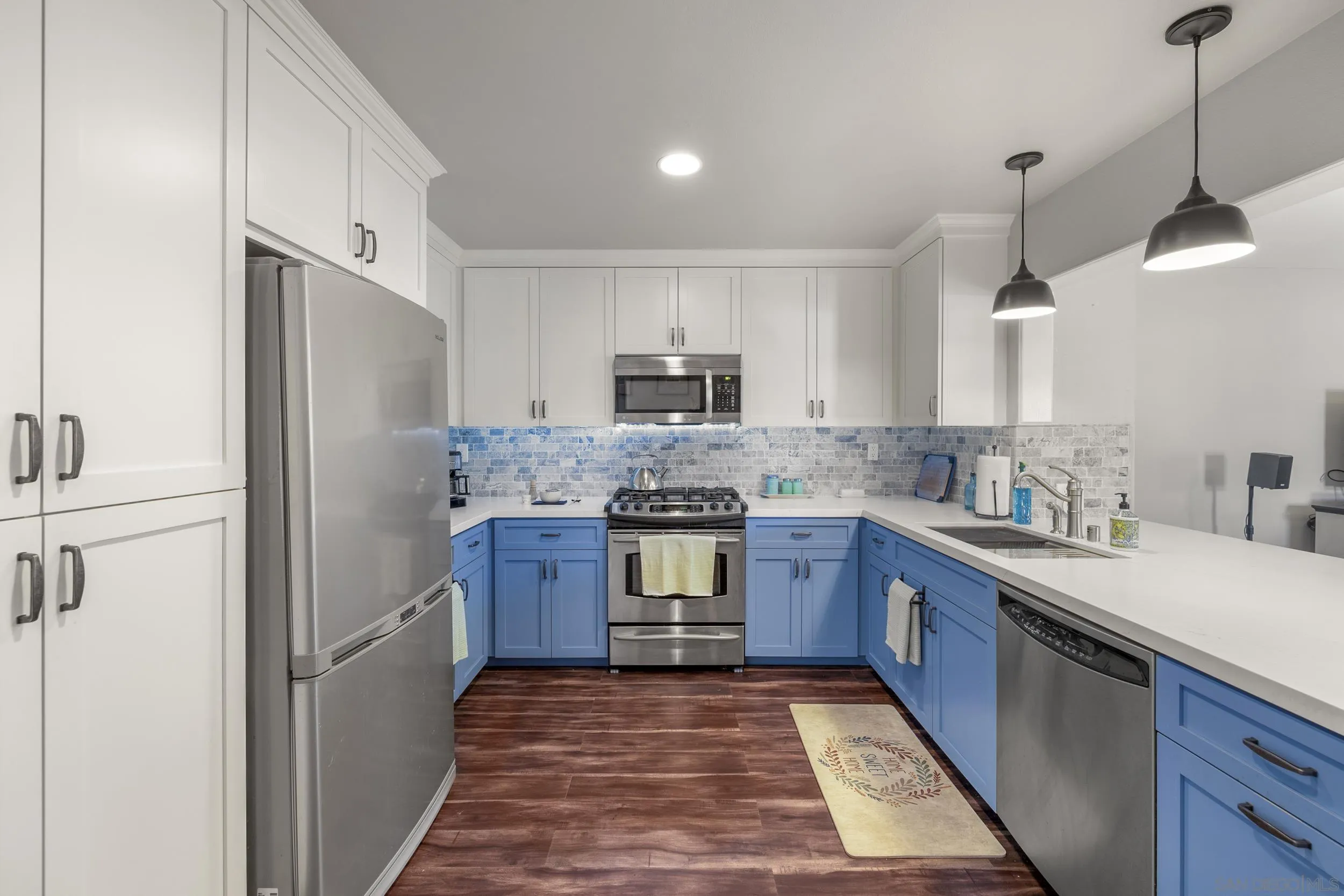 4652 Briar Ridge Road Oceanside, CA 92056 - Photo 7 of 34 a kitchen with granite countertop a refrigerator and a sink