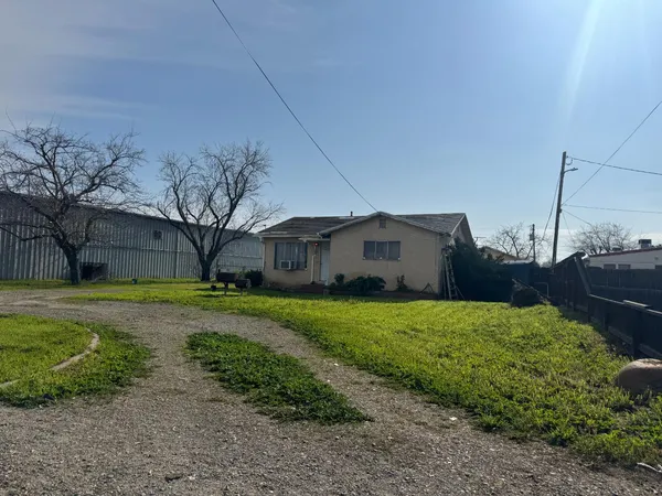 a front view of house with yard and trees