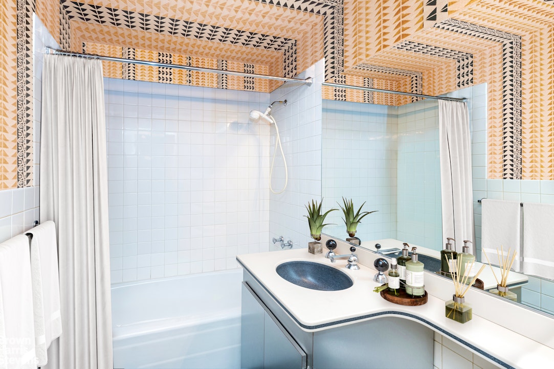 530 East 72nd Street, Unit 19E Manhattan, NY 10021 - Photo 7 of 15 a bathroom with a sink and a mirror