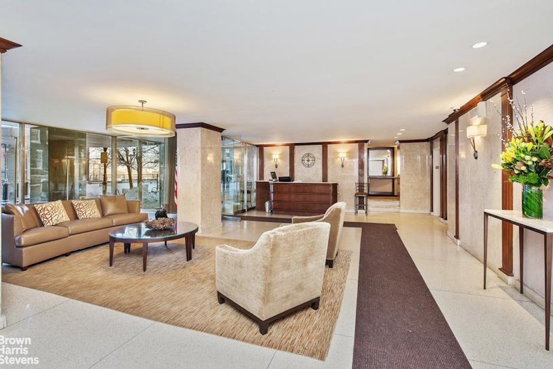 530 East 72nd Street, Unit 19E Manhattan, NY 10021 - Photo 8 of 15 a living room with furniture and a large window