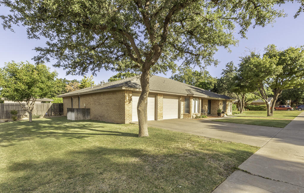 3620 93rd Street Lubbock, TX 79423 - Photo 3 of 33 a house that has a tree in front of it