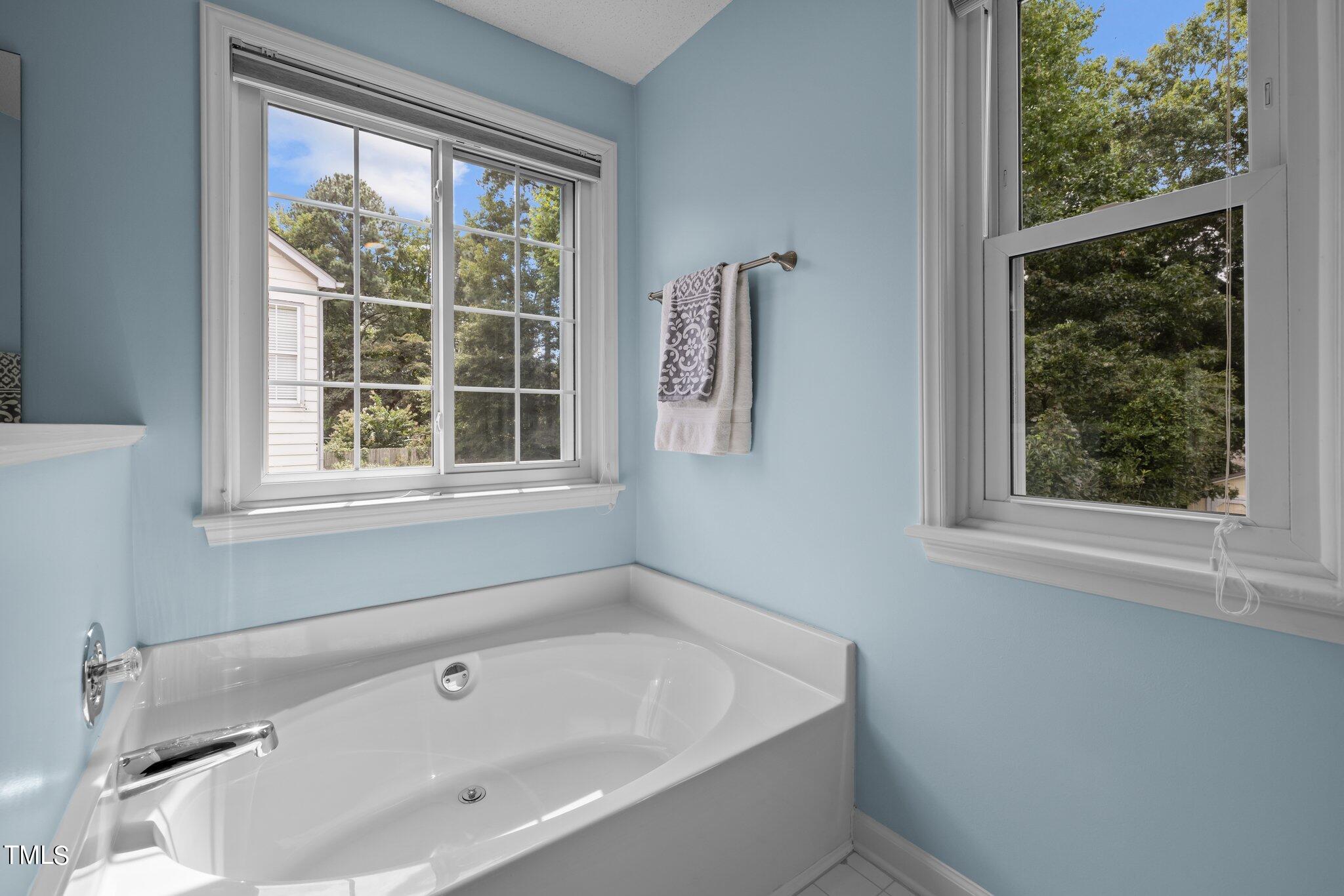 9421 Tweeds Mill Road Raleigh, NC 27617 - Photo 21 of 33 a bathroom with sink and a window
