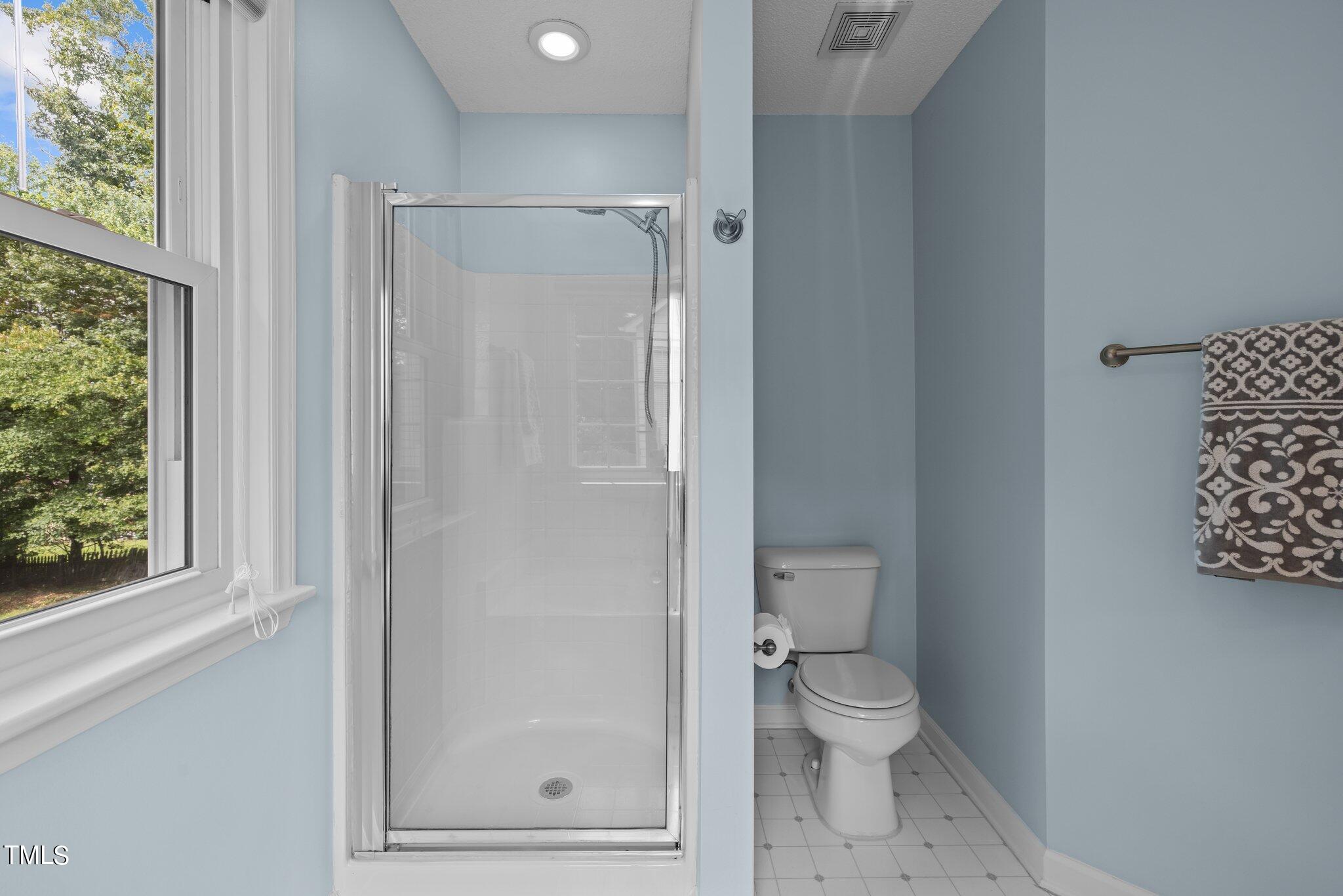 9421 Tweeds Mill Road Raleigh, NC 27617 - Photo 22 of 33 a bathroom with a toilet and a shower