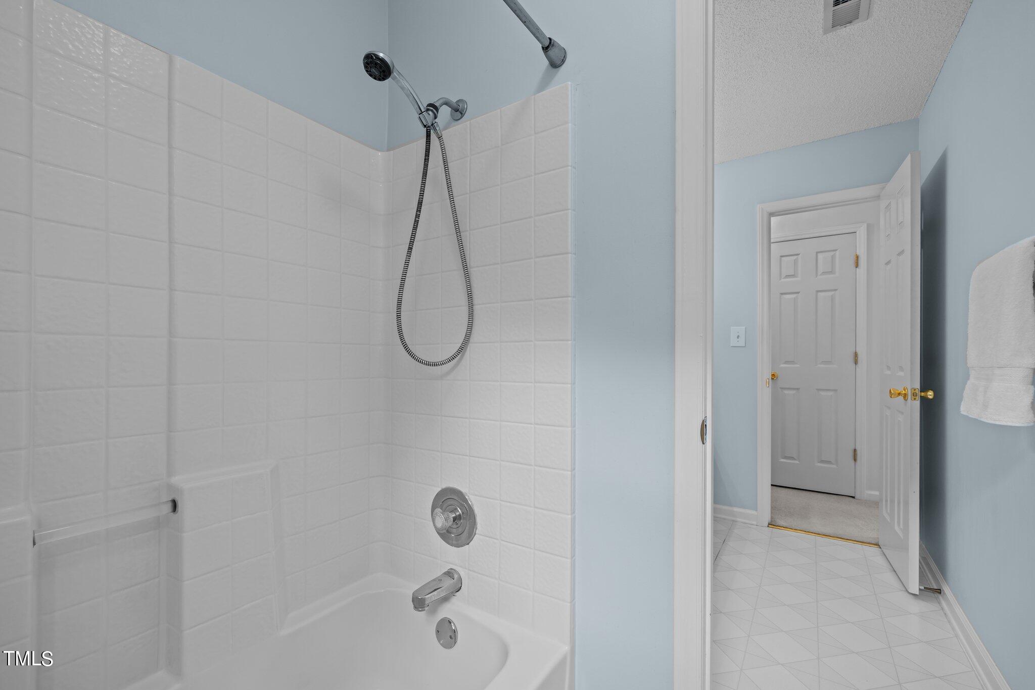 9421 Tweeds Mill Road Raleigh, NC 27617 - Photo 27 of 33 a bathroom with a bath tub with a shower