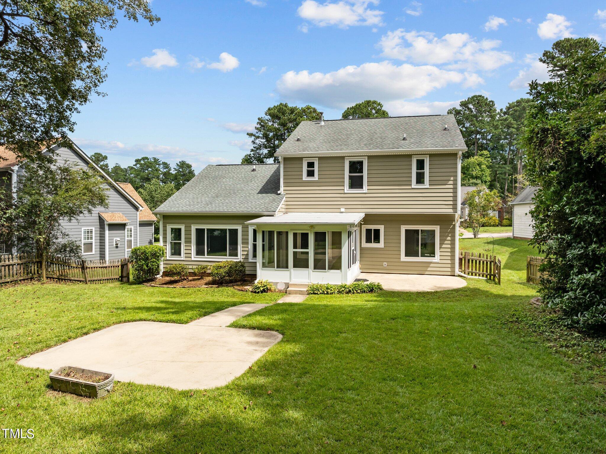 9421 Tweeds Mill Road Raleigh, NC 27617 - Photo 32 of 33 a front view of a house with a garden and trees