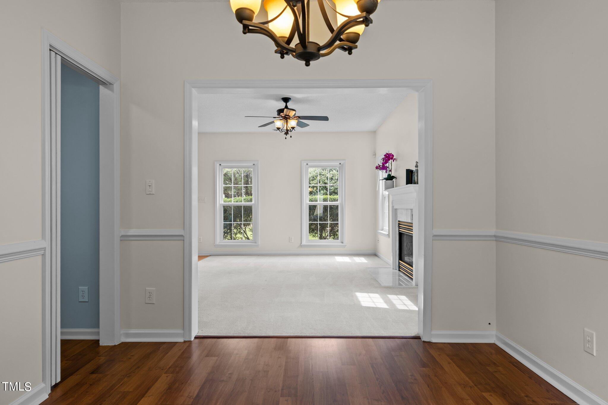 9421 Tweeds Mill Road Raleigh, NC 27617 - Photo 9 of 33 wooden floor in an empty room with a window