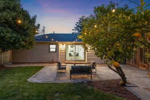 a view of a house with backyard porch and sitting area